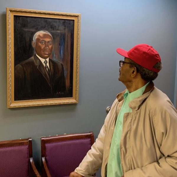 Ernie Campbell examines a portrait of Dr. Matthew Walker