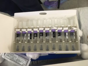 A tray of vials containing vaccines