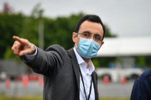Dr. Alex Jahangir gestures while wearing a mask.
