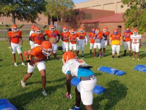 Football players at Hunters Lane High School square off on their first day of practice this fall.