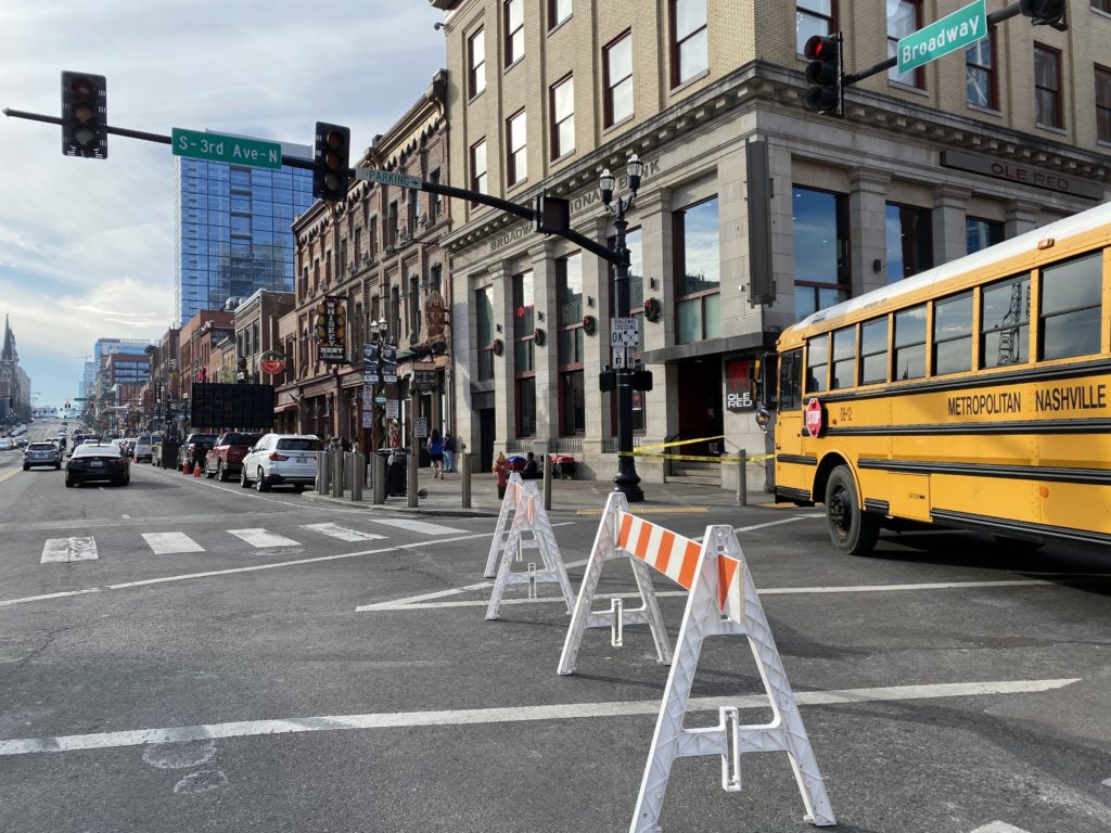 A school bus barricades Third Avenue at Broadway.