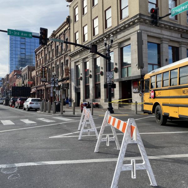 A school bus barricades Third Avenue at Broadway.