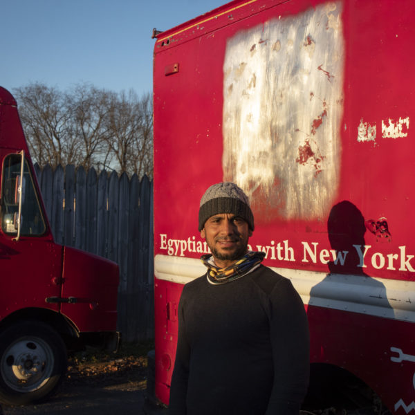 Business owner Ragab Rashwan stands in front of his food truck and restaurant.