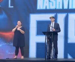 Dr. Michael Caldwell speaks in front of a Tennessee Titans mural.