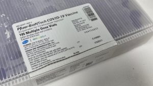 A box of vials containing the COVID-19 vaccine