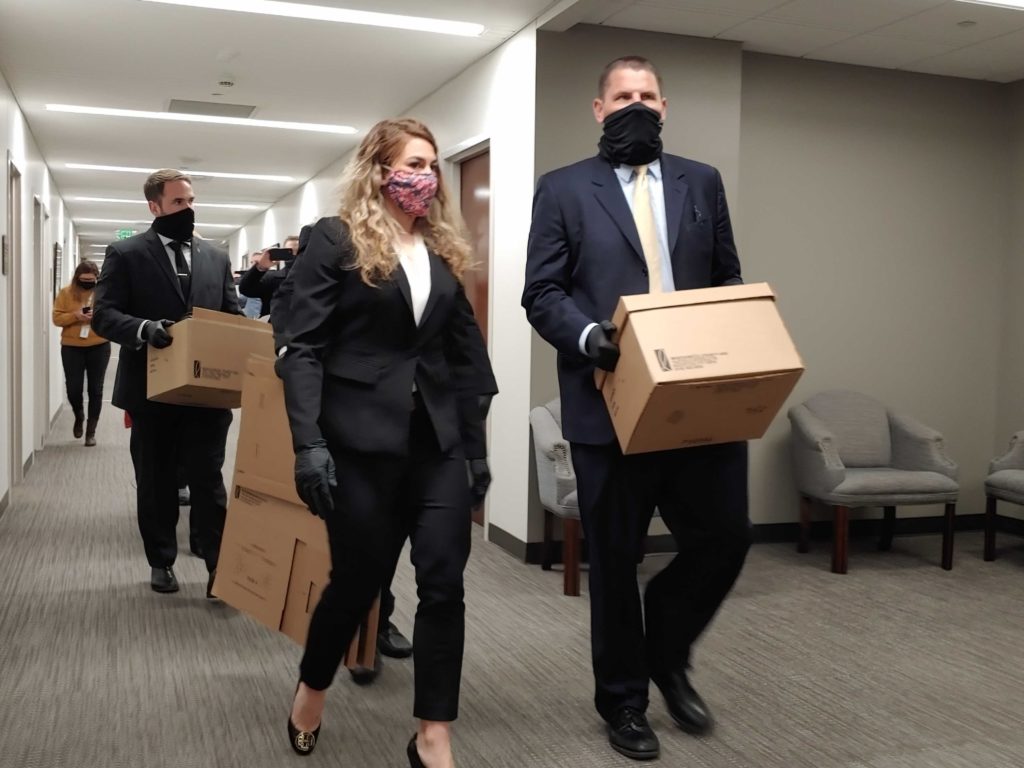 FBI agents leave the office of state Rep. Kent Calfee after executing a search warrant.