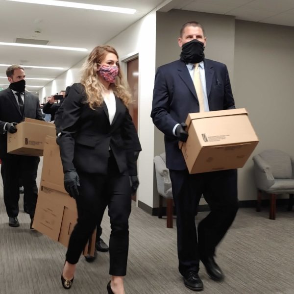FBI agents leave the office of state Rep. Kent Calfee after executing a search warrant.