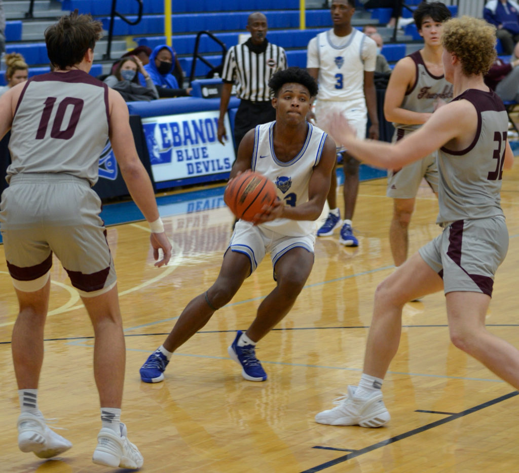 A player for Lebanon High School attempts to outmaneuver an opponent during a basketball game in 2020-21.