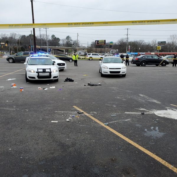 Police tape cordons off the parking lot where the shooting took place.