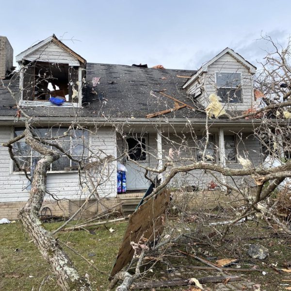 A home in Kingston Springs, Tennessee, with a fallen tree in the front yard and damaged windows.