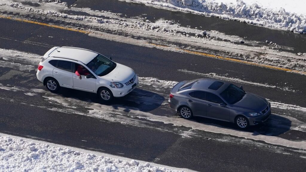 Stranded motorists wait for a tow on Interstate 95 in 2022 in Ladysmith, Va. A massive winter storm closed about 48 miles of the interstate.