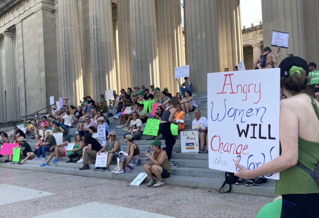 angry women will change the world sign