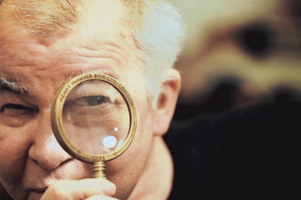 John Prine with magnifying glass