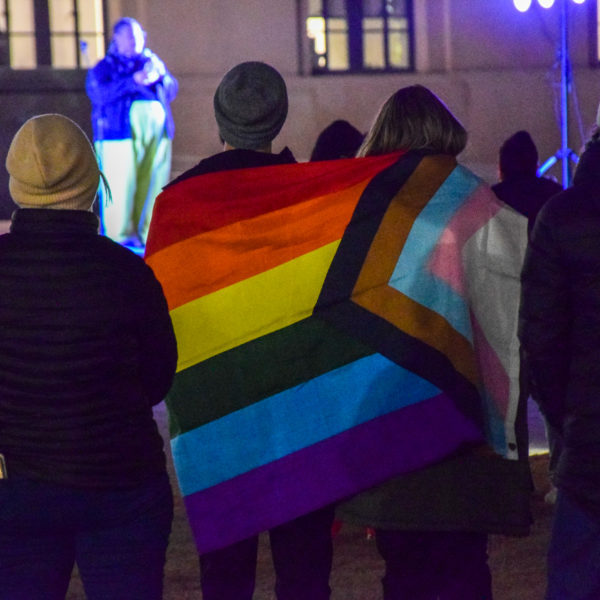 Two people wrapped in a pride flag attend a vigil Nashville for the victims of a mass shooting at an LGBT+ nightclub in Colorado Springs, Colorado on Nov. 19, 2022.