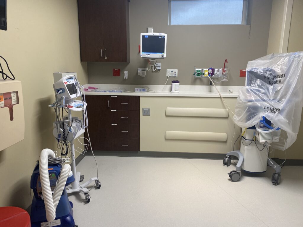 A curtained-off room in the donor wing at St. Thomas Ascension West. Several pieces of equipment like monitors, wheeled carts and pressure gauges.