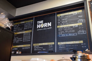 The Horn Coffee's chalkboard menu, featuring chai, coffee and sambusas.
