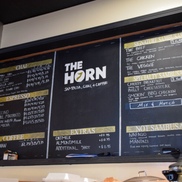 The Horn Coffee's chalkboard menu, featuring chai, coffee and sambusas.