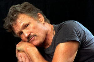 A photo of Kris Kristofferson with a black shirt on looking to camera