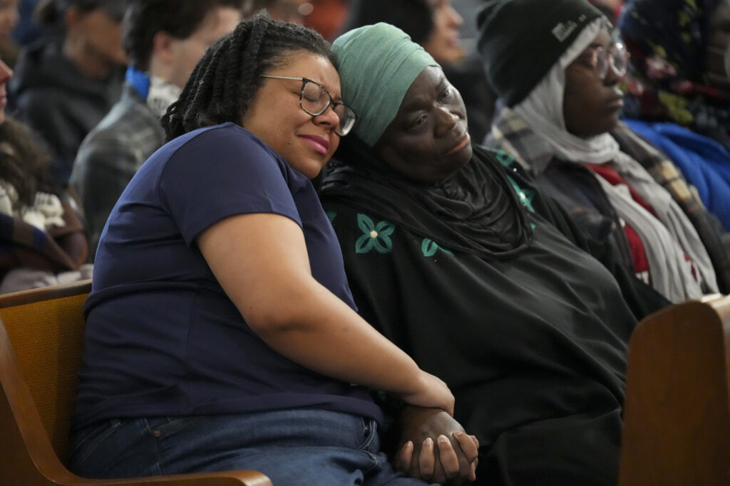 Council members Delishia Porterfield, left, and Zulfat Suara, right, console each other during a vigil for students that were killed and injured during the Antioch High School shooting. Porterfield has been instrumental in getting the Office of Youth Safety off the ground.