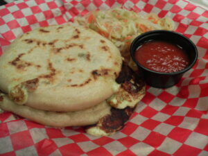 Flatbreads stuffed with meat and cheese, served with cabbage and tomato sauce.