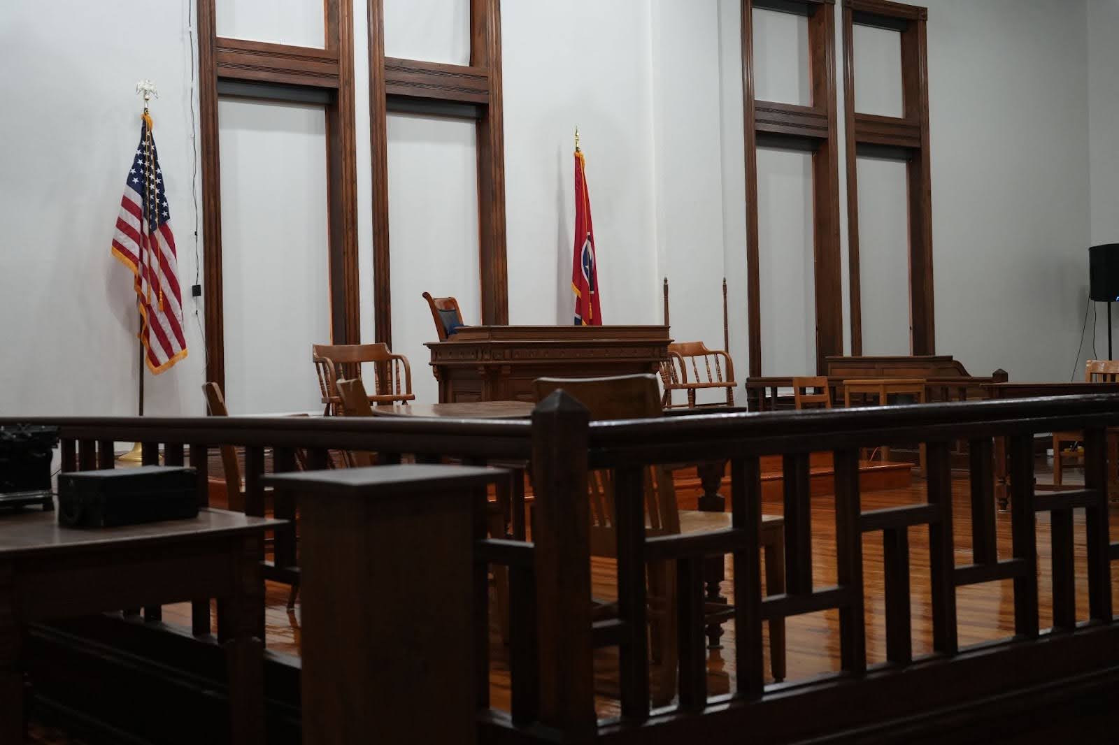 A judge's bench and other historic furniture in a courtroom.