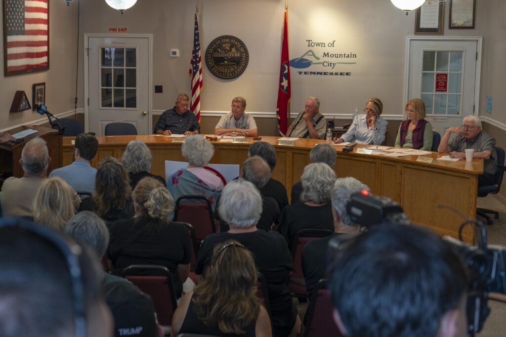The Mountain City Board of Mayor and Aldermen hear from locals at a town hall meeting on Thursday, Aug. 7, 2025. In a packed room of 50, 11 residents voiced their concerns that plans to build a 30 megawatt bitcoin mine in a residential part of Mountain City were being rushed by city leaders without proper input from the people who live nearby.