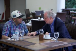 Senator Chris Van Hollen, right, sits with Kilmar Abrego Garcia — the Salvadorian citizen deported by the Trump administration — in El Salvador on Thursday