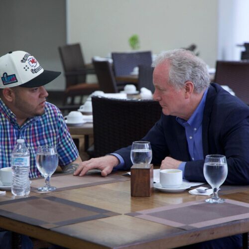 Senator Chris Van Hollen, right, sits with Kilmar Abrego Garcia — the Salvadorian citizen deported by the Trump administration — in El Salvador on Thursday