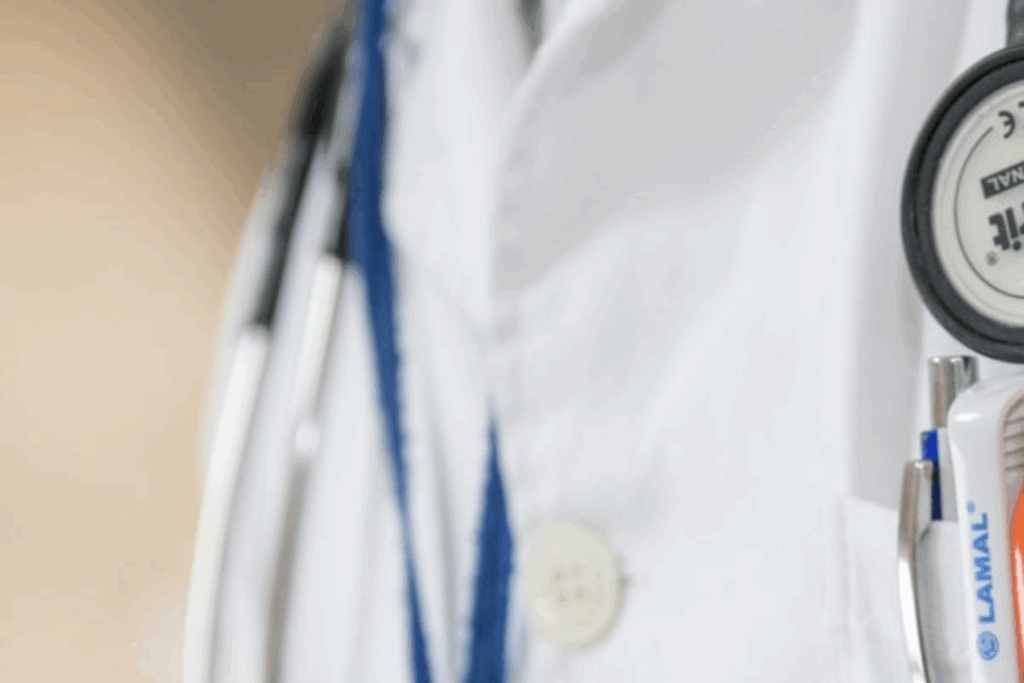 A doctor wearing a lab coat. Only the chest area and the stethoscope around their neck are visible.