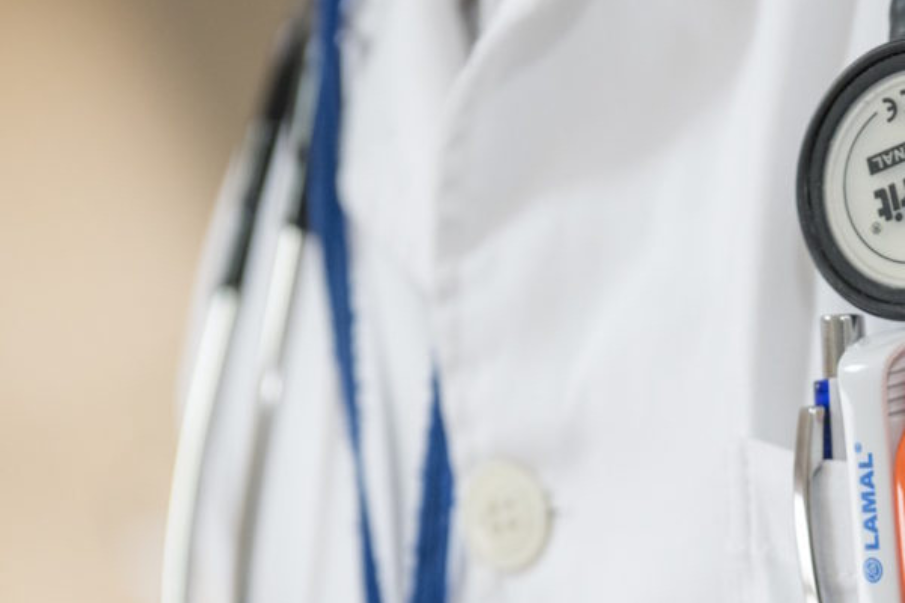 A doctor wearing a lab coat. Only the chest area and the stethoscope around their neck are visible.