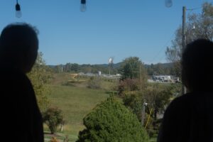 Mike (left) and Cynthia Trentham (right) look out at a fractionation plant operated by the NGL Supply Co., which moved in across the street from their family farm in Bulls Gap, Tenn., last year. They say the flame burns day and night, casting harsh light through their windows as they sleep and disturbing their cattle.