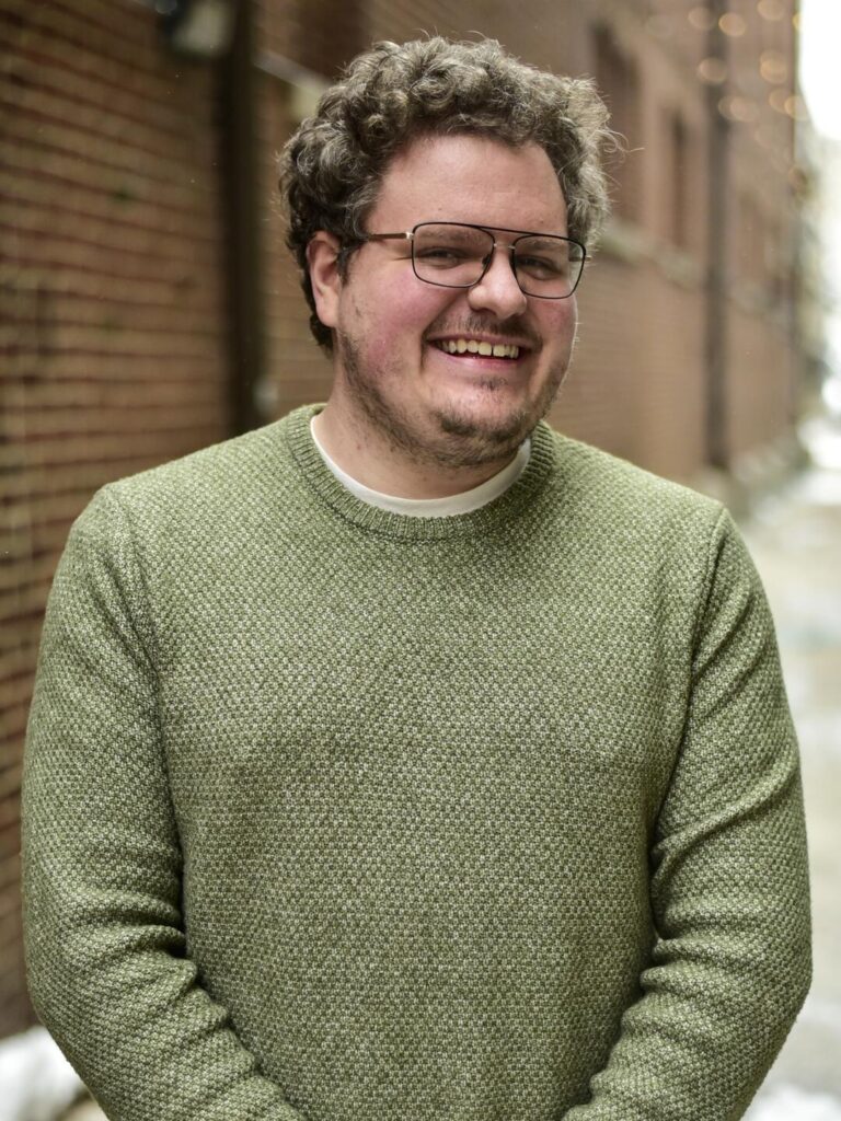 Andrew Henderson standing in an alley.