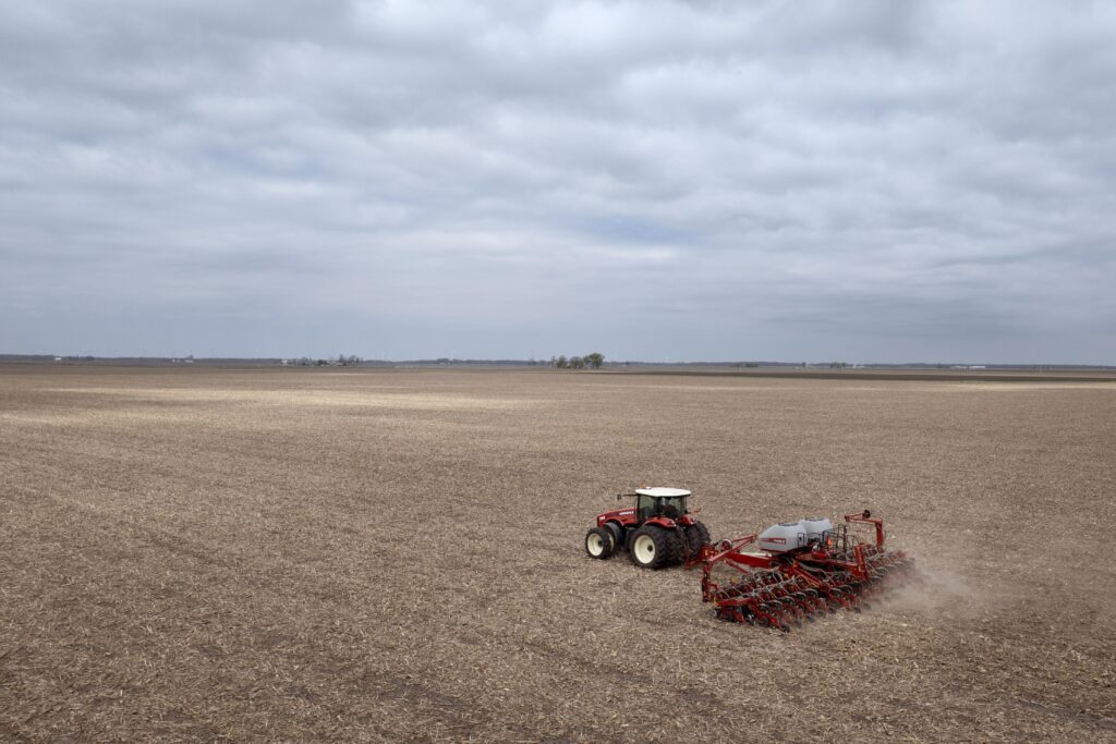 Dan Duffy uses a tractor to plant soybeans on land he farms with his brother on April 28, 2025 near Dwight, Illinois.