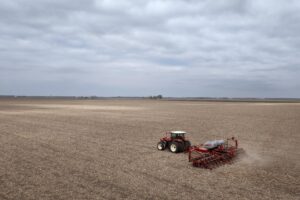 Dan Duffy uses a tractor to plant soybeans on land he farms with his brother on April 28, 2025 near Dwight, Illinois.