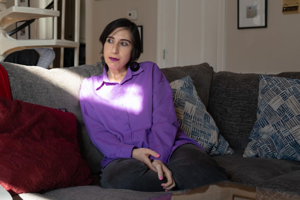 Tamar Shirinian sits on the couch in her Knoxville home on Wednesday, Nov. 26, 2025. Shirinian is a cultural anthropologist who had previously worked for 6 years as an assistant professor at the University of Tennessee until she was fired for making a private Facebook comment critical of conservative activist Charlie Kirk after his Sept. 10 assassination.