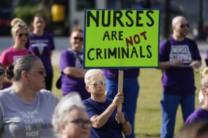 People demonstrate outside the courthouse where the sentencing hearing for former nurse RaDonda Vaught was held on May 13, 2022, in Nashville, Tenn.