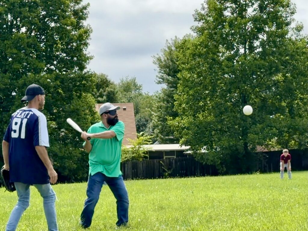 Israel Cazares, who's blind, prepares to swing at a beep ball. He wears a blindfold, which is standard in the sport, to make sure everyone plays with the same level of vision impairment.