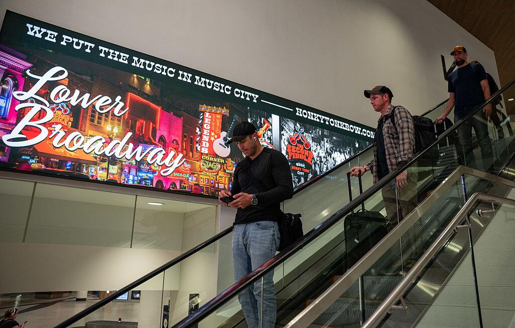 Travelers descend an escalator at Nashville International Airport, which has seen explosive growth over the past decade.