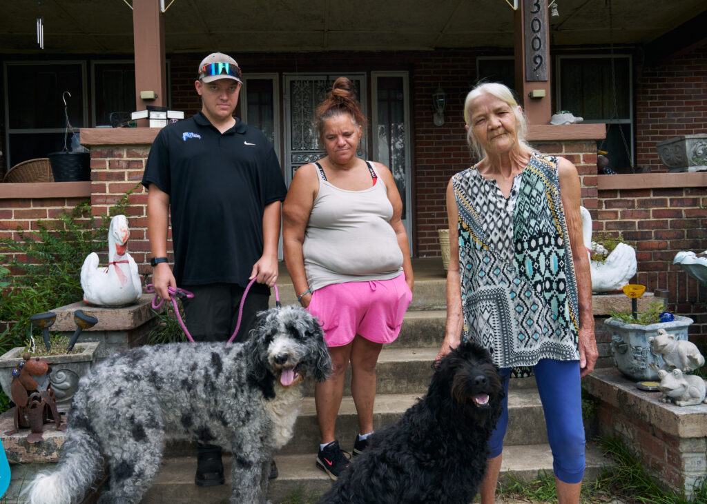 From left, Thomas Jarvis, his mother Crystal Lobdell, and his grandmother Chris Stone stand with their family dogs, Trip and Pepper, in front of their home.