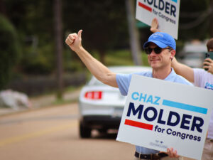 Chaz Molder gives a thumbs up to voters as they pass a Memphis polling place.