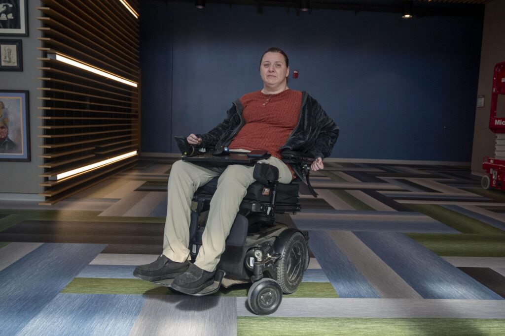 Erica Carter of Sioux City, Iowa, is seated in a motorized wheelchair.