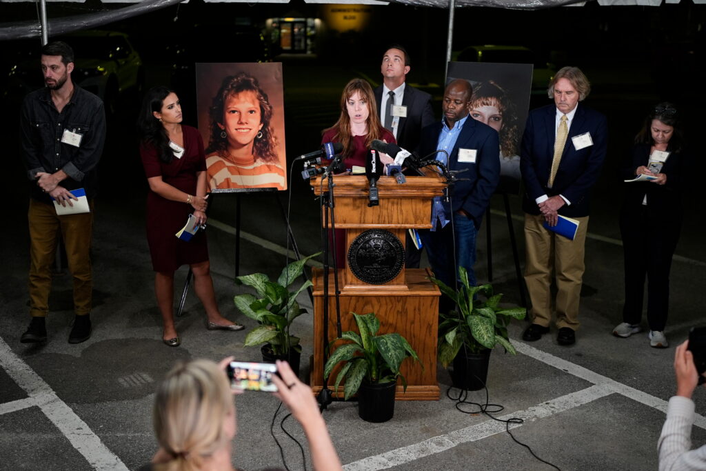 Public radio reporter Catherine Sweeney, one of the media witnesses, recounts the moments before the execution of Christa Pike was halted last Wednesday, Sept. 30. (AP Photo/George Walker IV) Flanking the podium are two photos of Colleen Slemmer, Pike's victim in the 1995 murder.