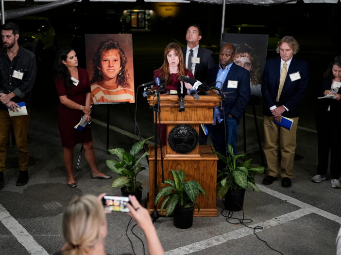 Public radio reporter Catherine Sweeney, one of the media witnesses, recounts the moments before the execution of Christa Pike was halted last Wednesday, Sept. 30. (AP Photo/George Walker IV) Flanking the podium are two photos of Colleen Slemmer, Pike's victim in the 1995 murder.